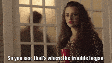 a woman holding a red cup with the words so you see that 's where the trouble began