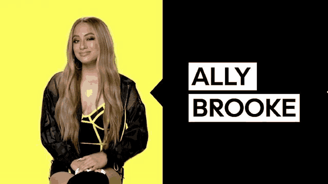 ally brooke is sitting in front of a black and yellow background .