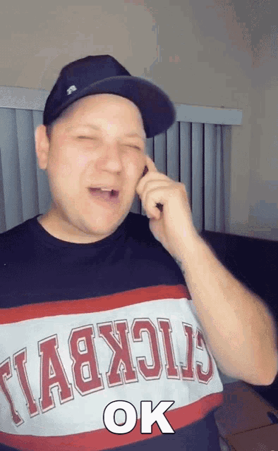 a man wearing a t-shirt that says ok on it