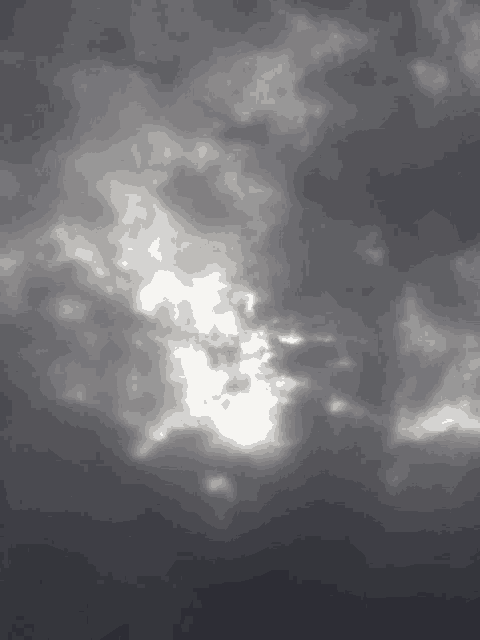the sun shines through the clouds in a dark sky