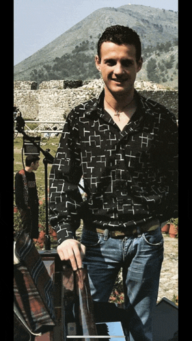 a man in a black shirt with a cross on it