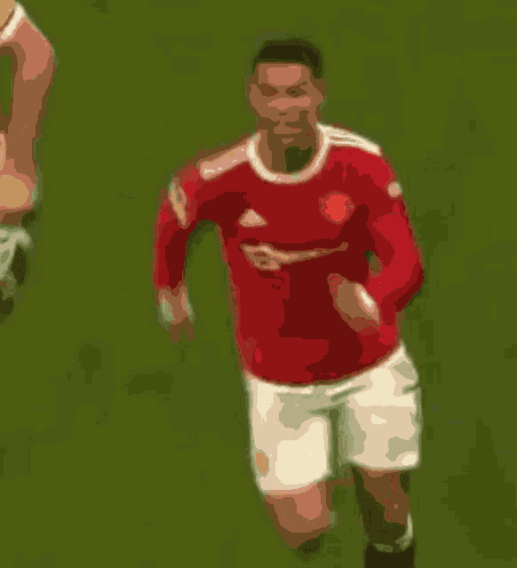 a soccer player in a red jersey with the letter b on the front
