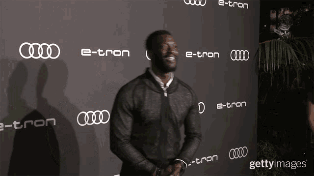 a man stands in front of an audi e-tron wall