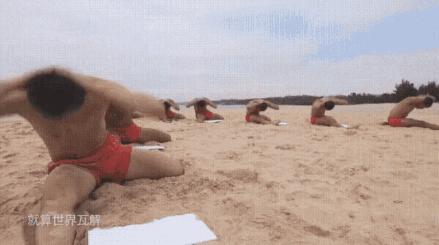 a group of men stretching on a sandy beach with chinese writing