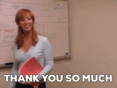 a woman is standing in front of a whiteboard with the words thank you so much written on it .