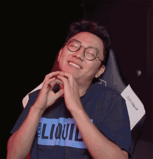 a man with glasses and a shirt that says liquid