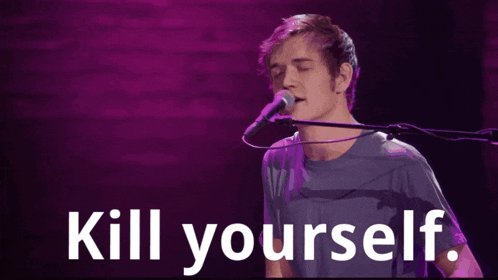 a man singing into a microphone with the words kill yourself written below him