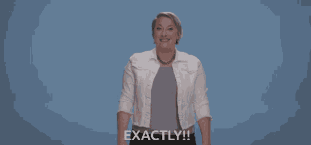 a woman in a white jacket and gray shirt says exactly