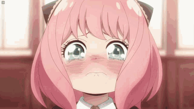 a girl with pink hair and green eyes is crying with tears coming out of her eyes
