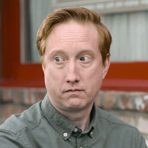 a man with red hair is making a silly face