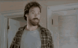 a man in a plaid shirt is making a funny face and saying `` is like oatmeal '' .