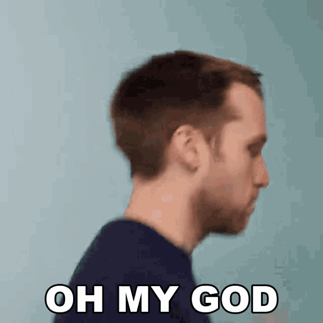 a man in a blue shirt is making a funny face and saying oh my god