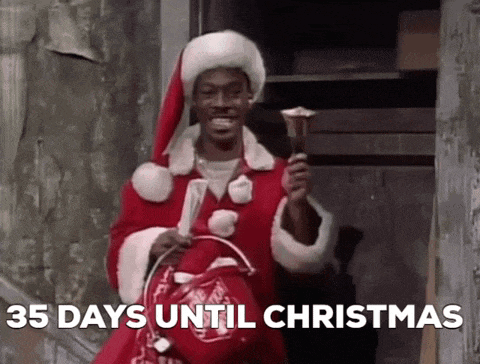 a man in a santa claus costume is holding a bell and a bag .