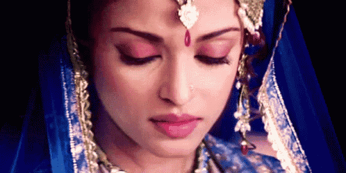 a close up of a woman 's face with her eyes closed .