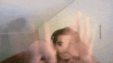 a blurry picture of a person 's face with a pink background