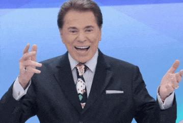 a man in a suit and tie is smiling and making a funny face