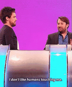 two men on a stage with one saying i don t like humans touching me