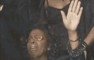 a woman is holding her hands up in the air .