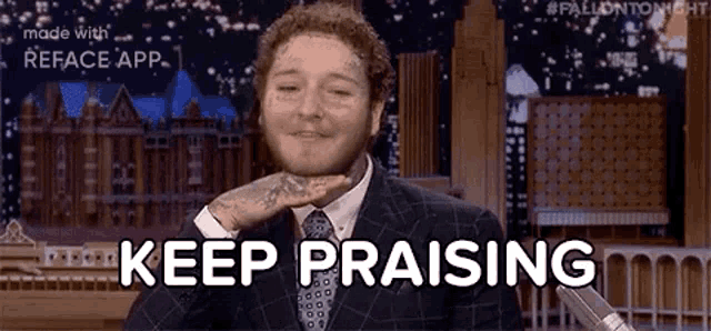 a man in a suit and tie is holding his hand to his face and saying keep praising .