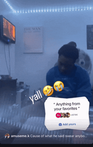 a screenshot of a man sitting in front of a tv with a sticker that says " anything from your favorites "