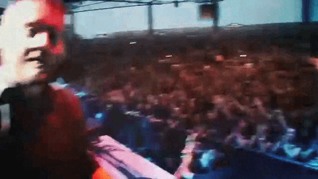 a man is standing in front of a crowd of people