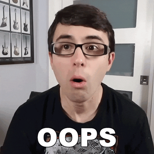 a man wearing glasses and a shirt that says oops on it