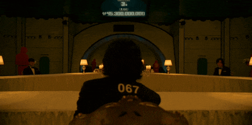 a person with the number 067 on their back sits at a table