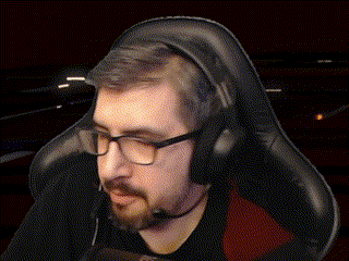 a man with glasses and a beard is wearing headphones and a microphone .