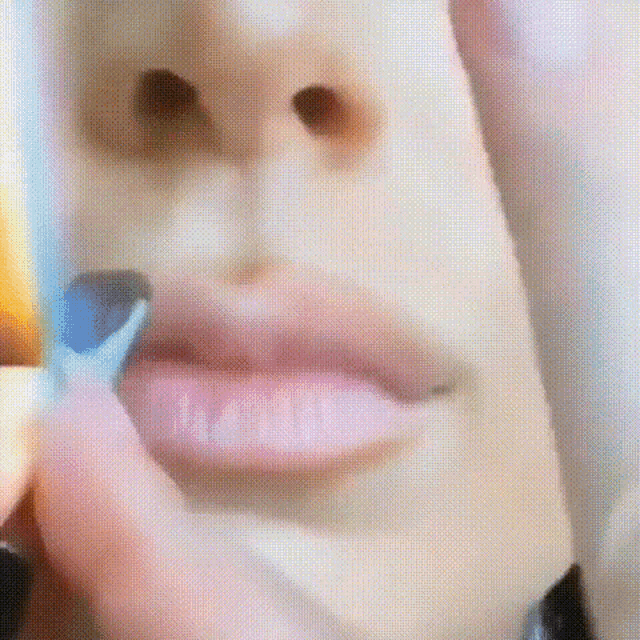 a close up of a person 's face with a rainbow in the background