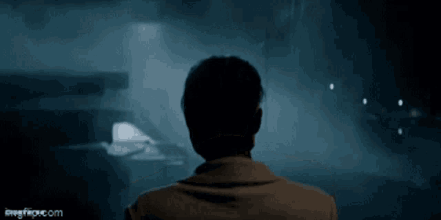 a man 's back is shown in a dark room with a watermark that says imgflip.com