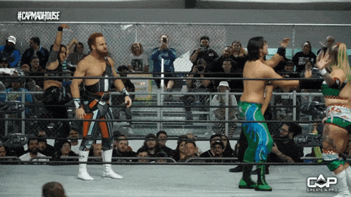 a group of wrestlers standing in a ring with the caption #capmaxhouse