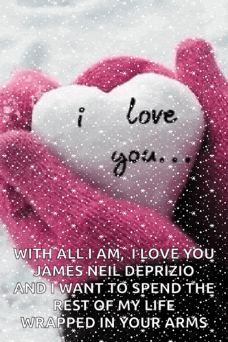 a pink glove is holding a white heart that says i love you