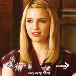 a blonde woman is sitting on a couch and says very very hard
