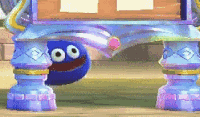 a blue cartoon character with big eyes is standing under a table .