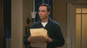 a man in a suit is standing in a living room with papers falling from the ceiling