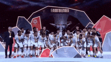 a group of soccer players are posing for a picture with a trophy that says campeones