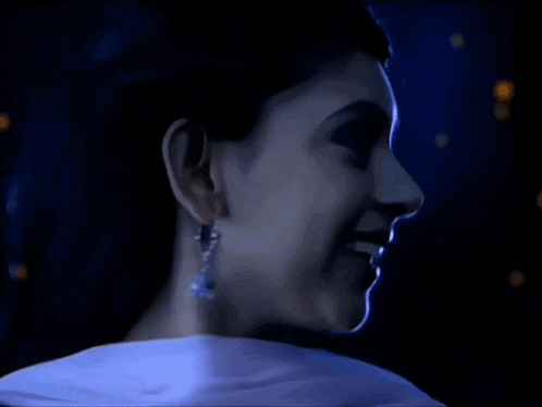 a close up of a woman 's face in the dark