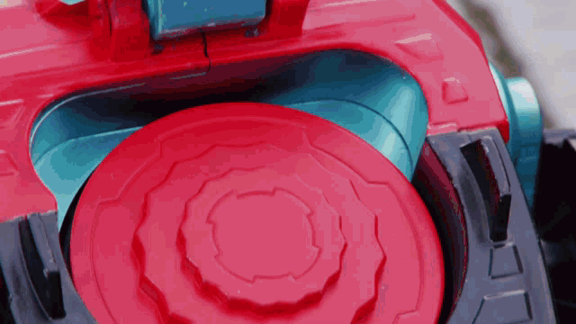 a close up of a red and blue toy with the letter d on the bottom