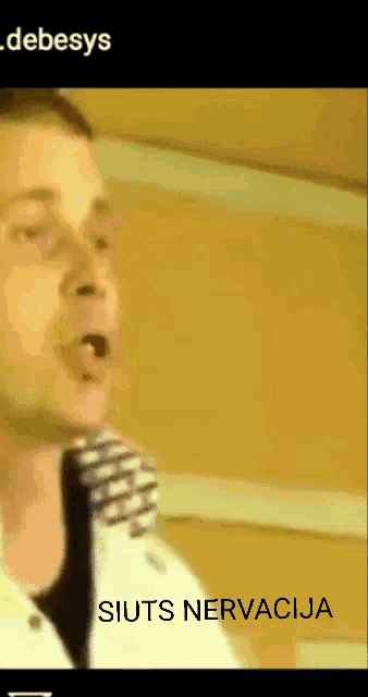 a man singing into a microphone with the words " siuts nervacija " underneath him