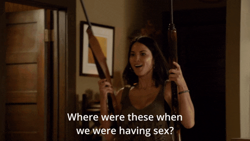 a woman holding a gun with the words " where were these when we were having sex " above her