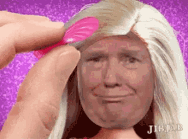 a person is brushing donald trump 's hair with a pink brush .