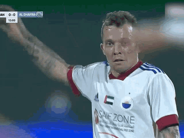 a soccer player wears a shirt that says saif zone on it