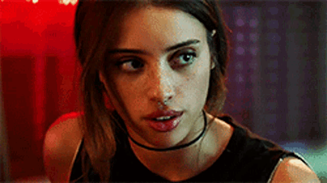 a close up of a woman wearing a choker necklace