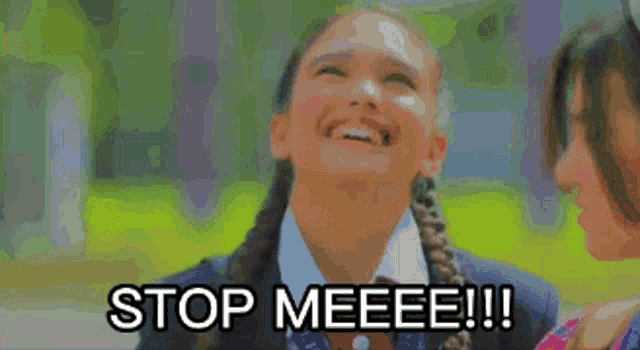 a girl in a school uniform is laughing with the words stop meeeee !!! below her