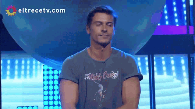 a man with his eyes closed wearing a shirt that says night cruise on it