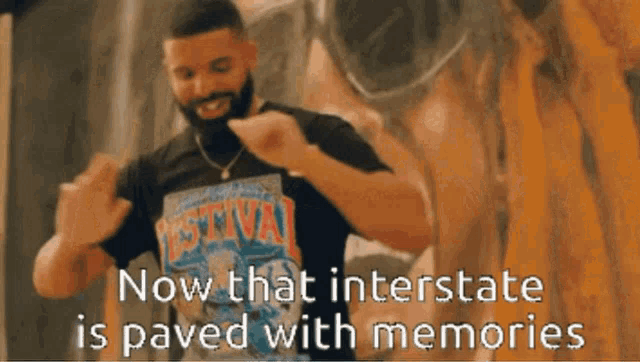 a man with a beard is wearing a black shirt that says festival