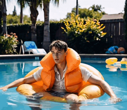 a man wearing an orange life jacket is floating in a pool