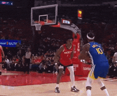a basketball player with the number 10 on his jersey is playing against another player