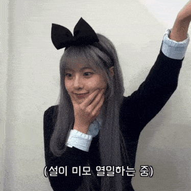 a girl with gray hair and a bow on her head