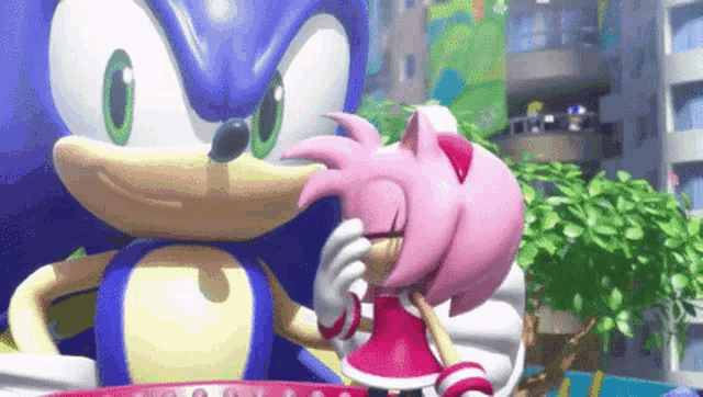 sonic the hedgehog and amy rose are standing next to each other .